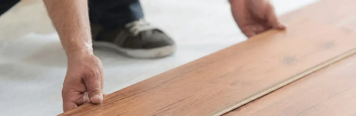 A professional installing laminate flooring in Tallahassee, FL